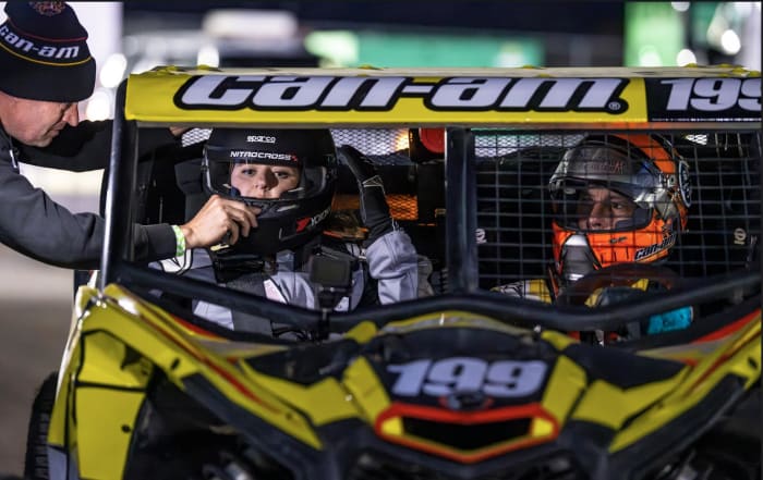 Auto Racing Digest's Victoria Beaver (left) gets set to go play in the sand with Travis Pastrana behind the wheel (right). Photo: Long Nguyen.